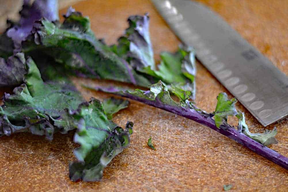Removing stems from purple kale
