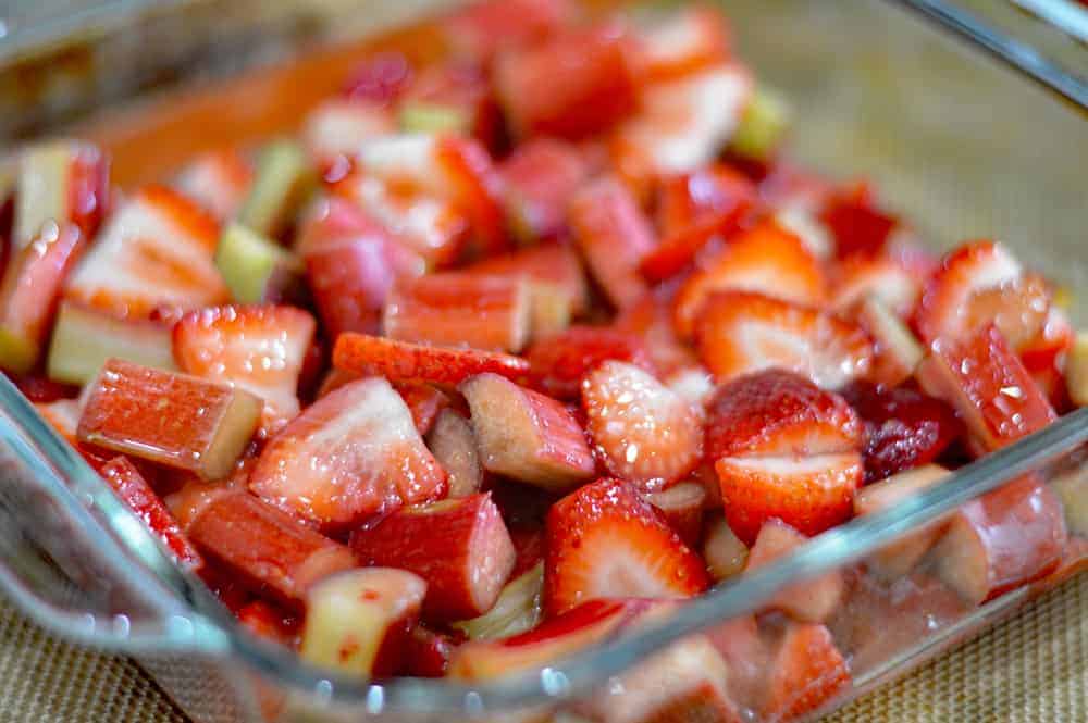 Marinated strawberries and rhubarb in a glass baking dish