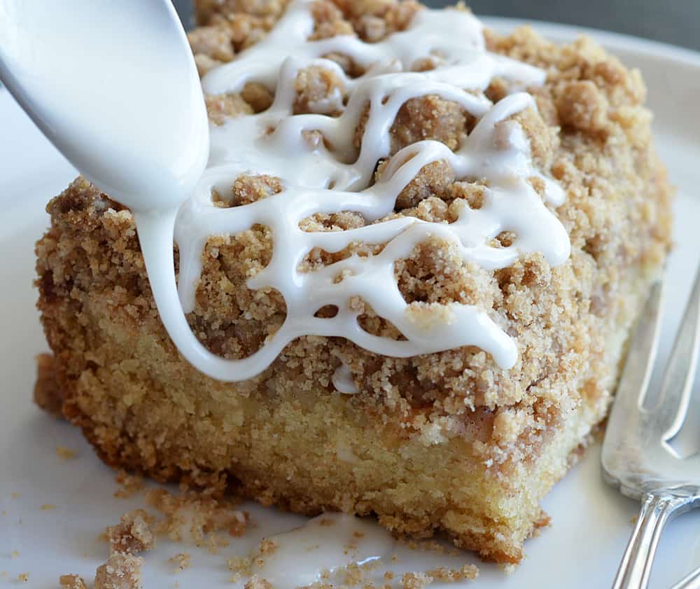 Drizzling glaze over apple crumb cake