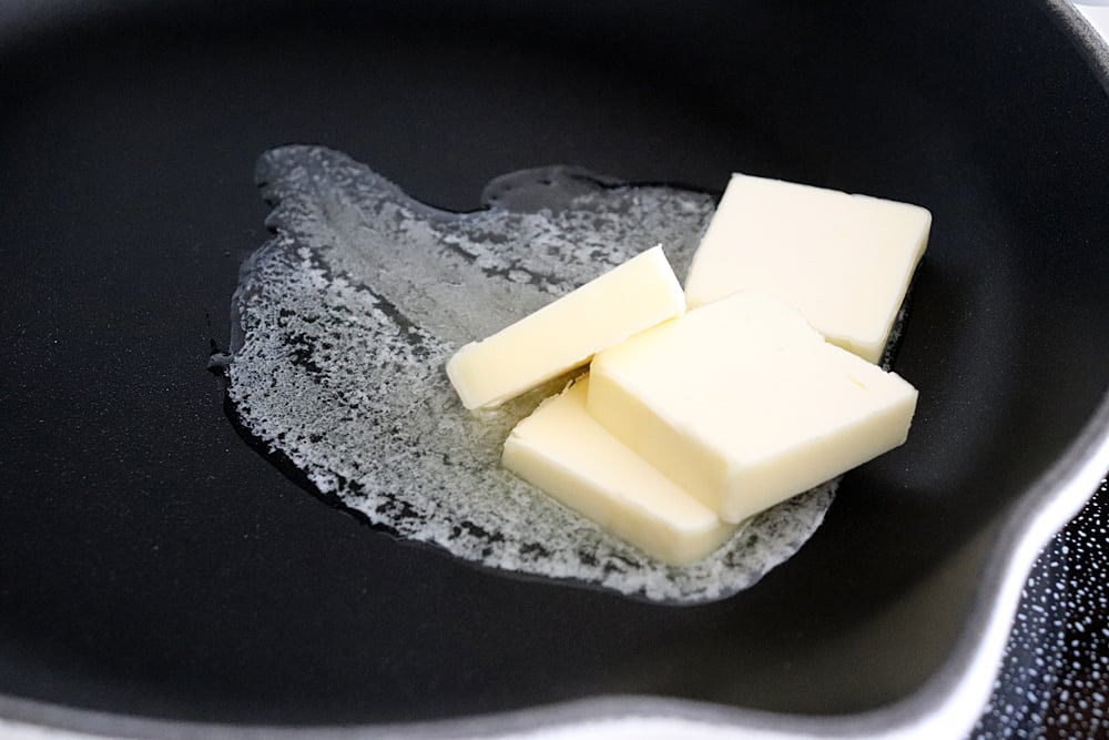 Melting butter in a black skillet