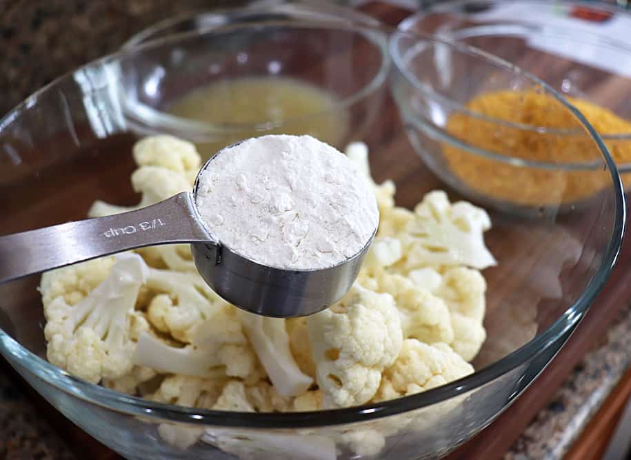 Adding flour to cauliflower