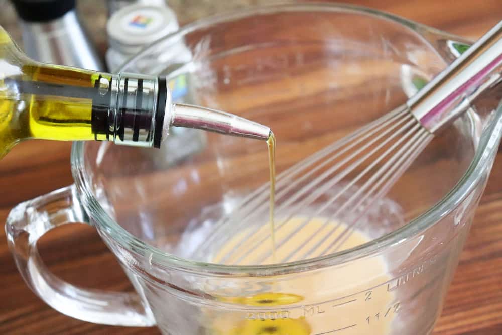 Drizzling olive oil into mustard for Warm Potato Salad with Dijon Vinaigrette