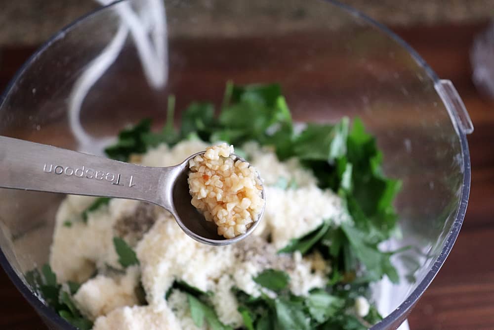 Adding minced garlic to the food processor