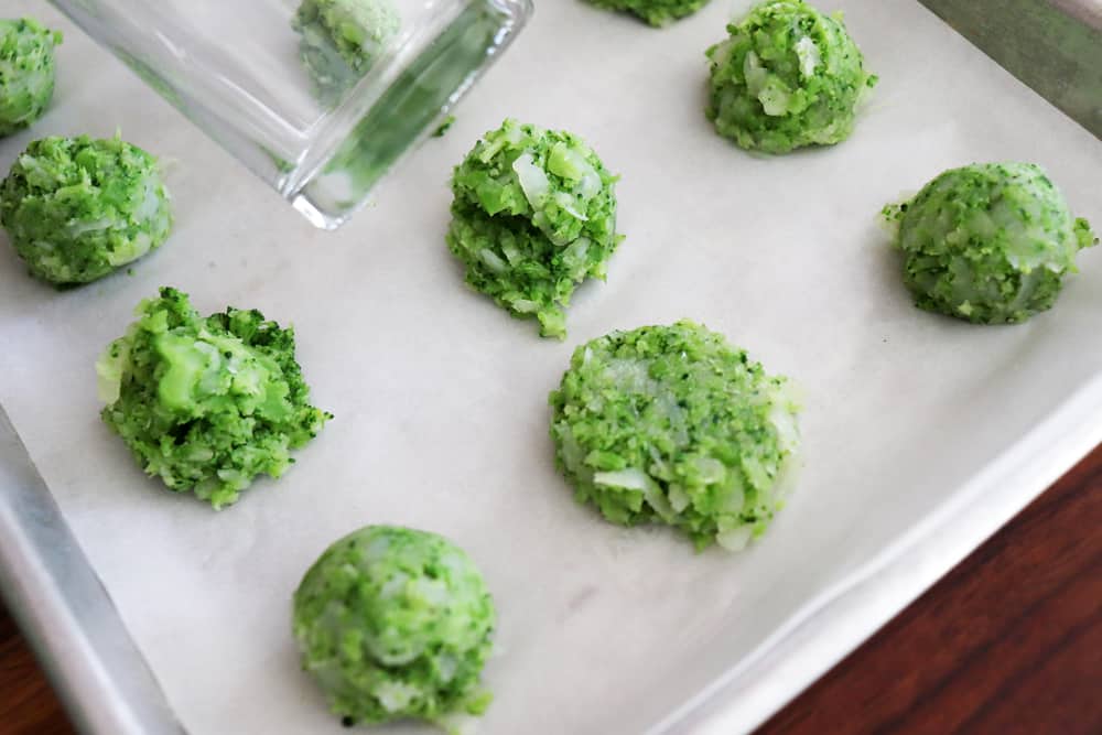 Pressing the broccoli tots with a glass to flatten into crowns