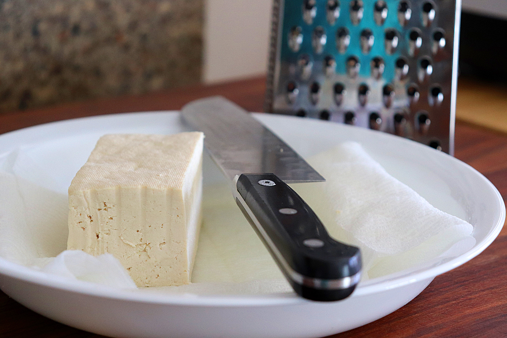 Grate the tofu on a boxed grater