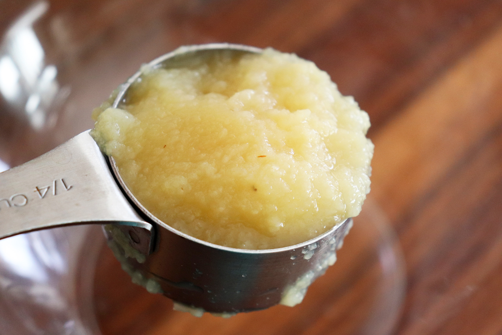 Adding applesauce to a glass bowl