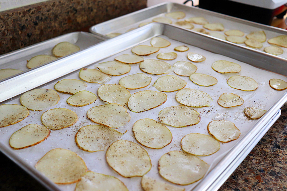 Arranging the potato slices on sheet pans
