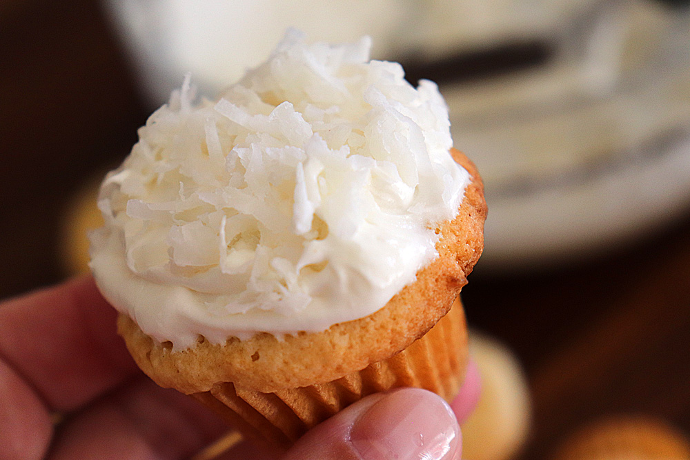 Bite shot of Vegan Coconut Cupcakes with Coconut Frosting